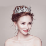 Diamond Studded Crown cake topper worn by an asian woman 
